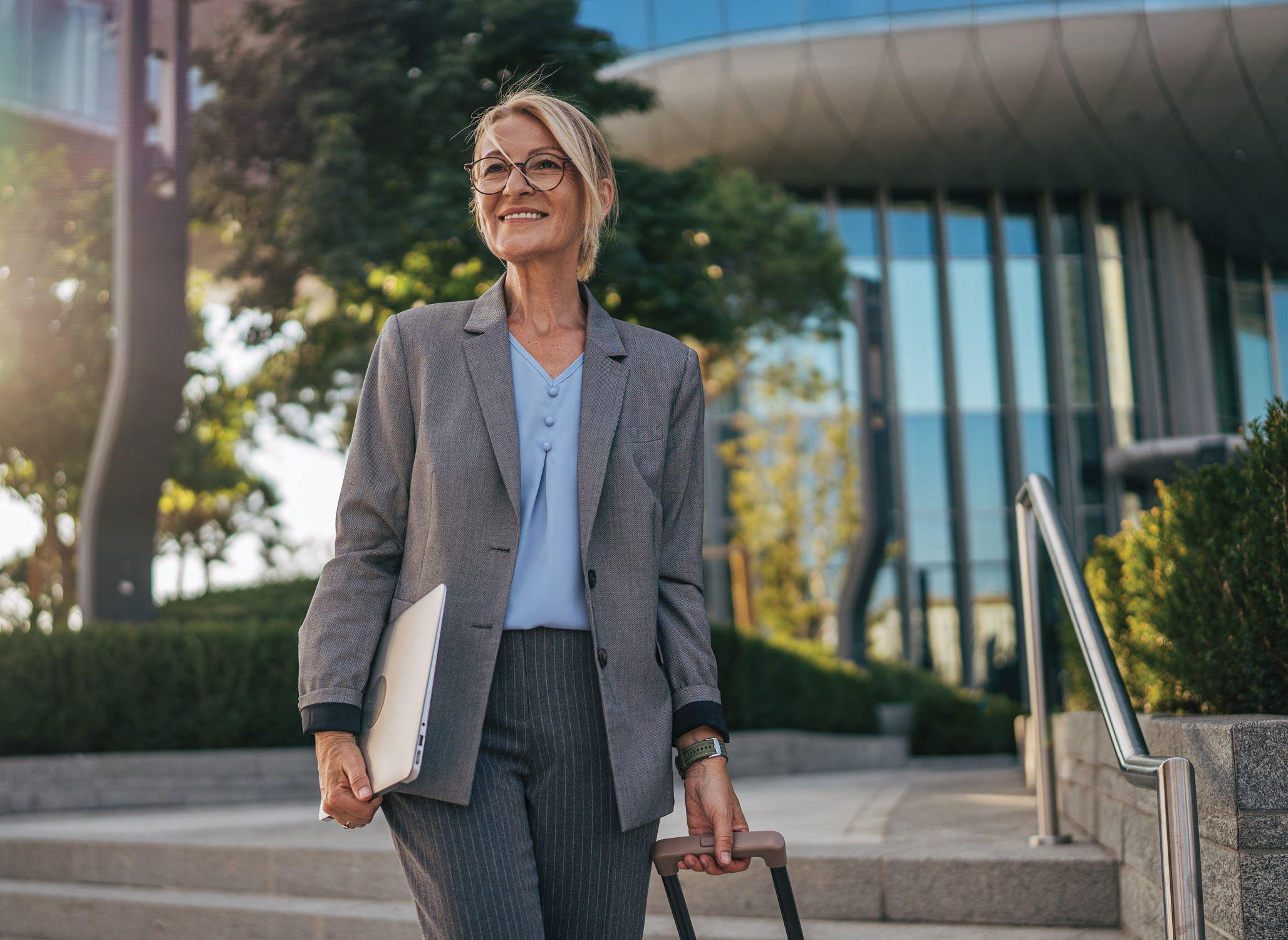 Business women walking outside with her luggage