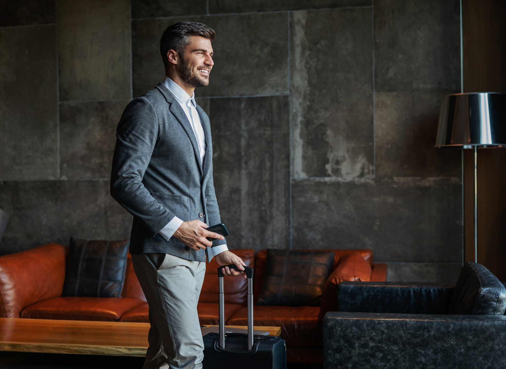 Business traveler wheeling their luggage through the hotel reception