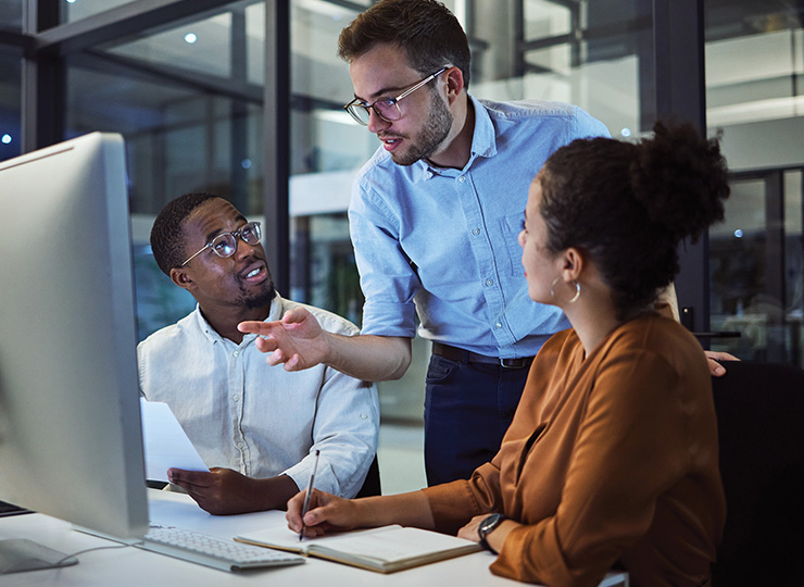 Three work colleagues discussing business travel ROI