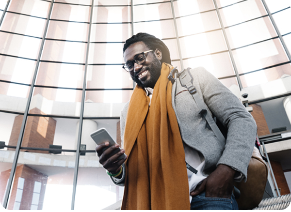 Business traveler looking at mobile phone