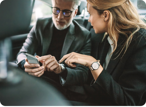 Business travelers checking mobile phone in ride share service