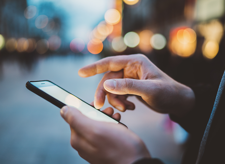 Man demonstrating online adoption - Close up of man's hands holding mobile phone